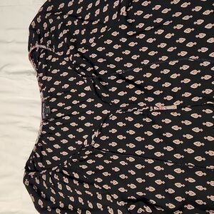 tassles and design around the bottom of top and bottom and bottom of sleeves